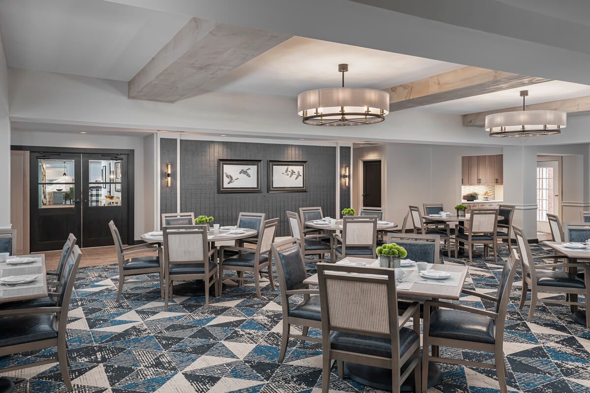 A modern dining room with elegant chandeliers and stylish seating arrangements.
