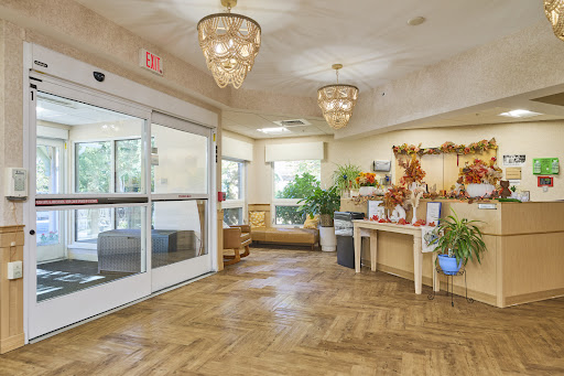 A warm and inviting lobby featuring elegant chandeliers and lush greenery.