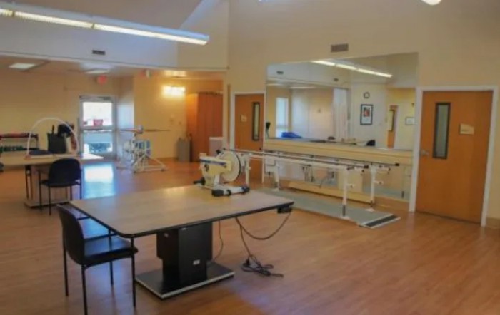 A physical therapy room equipped with various exercise tools and rehabilitation equipment.