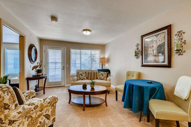 A cozy living room featuring elegant furniture, a round coffee table, and tasteful decor.