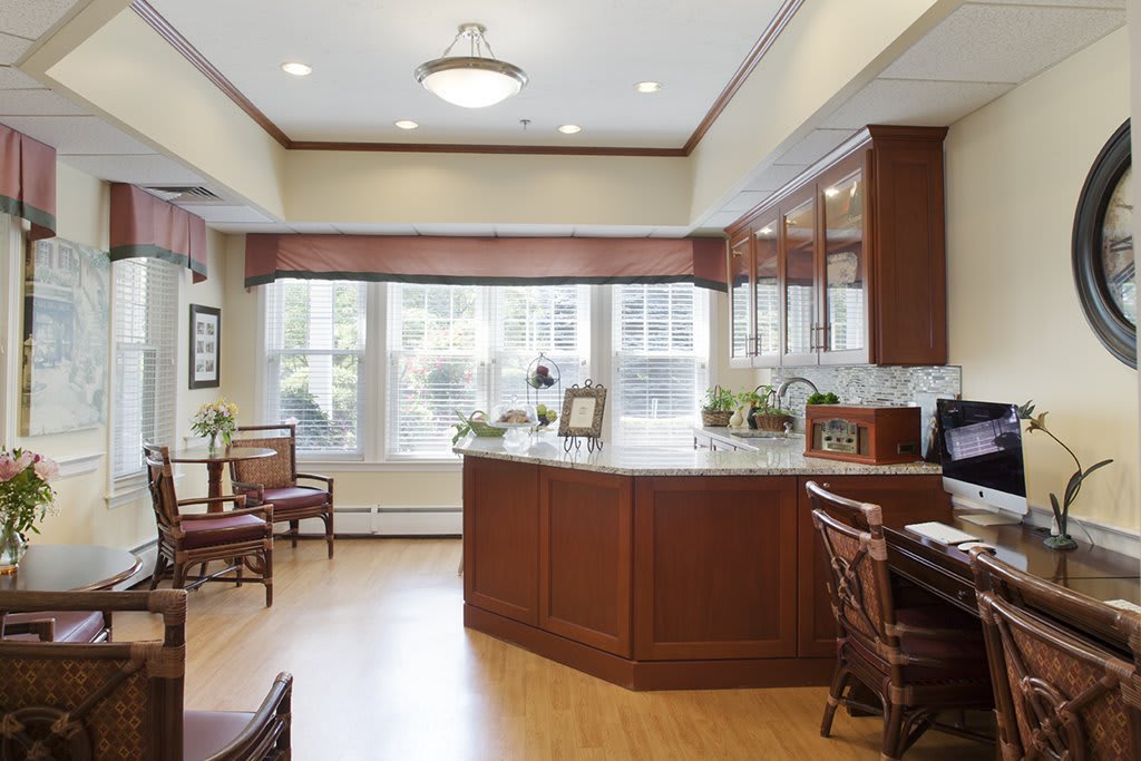 A spacious office interior with wooden furniture and large windows.
