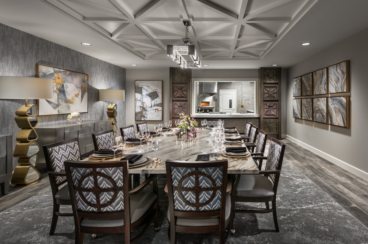 Elegantly designed dining room with a sophisticated table setting and artwork on the walls.