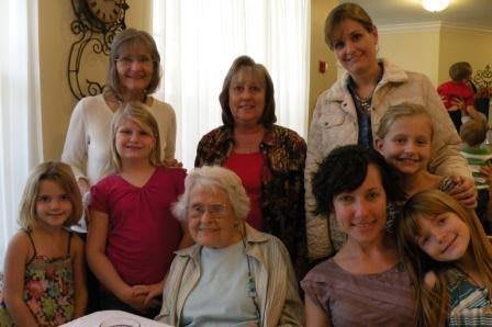 A group of people posing together for a family photo.