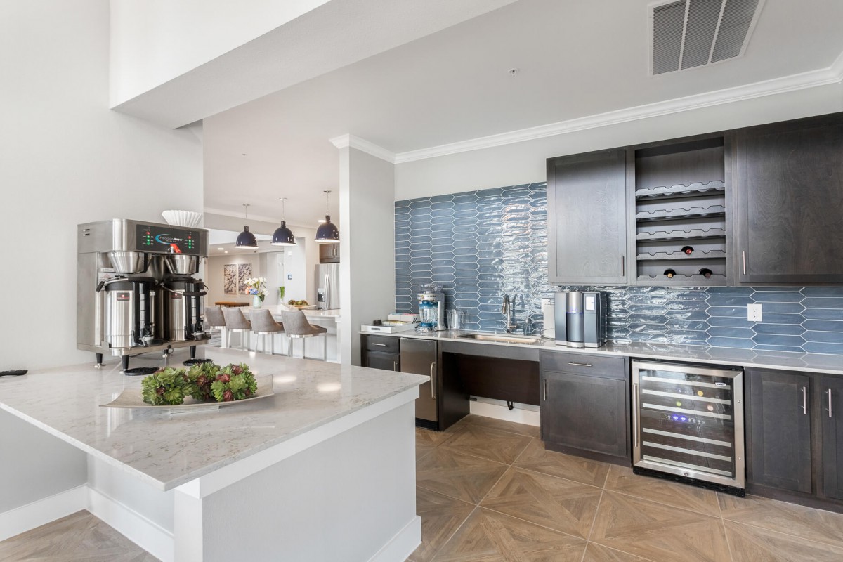 A modern kitchen with sleek appliances and a stylish backsplash.