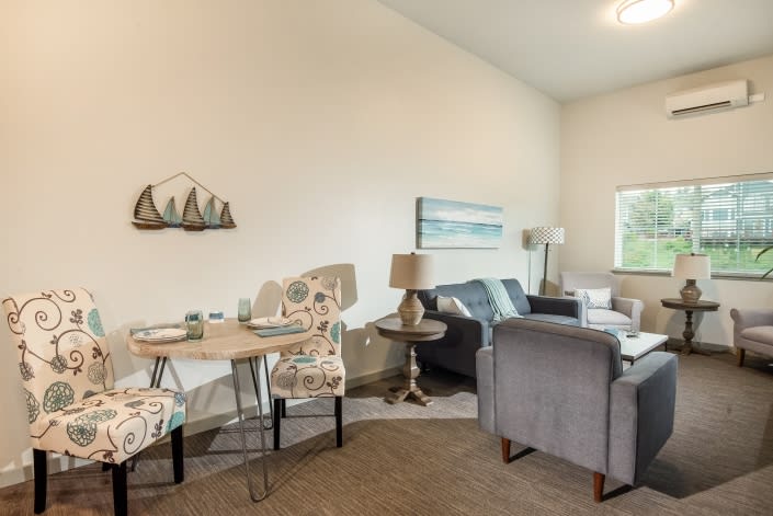 A cozy living and dining area featuring comfortable seating, decorative wall art, and modern furnishings.