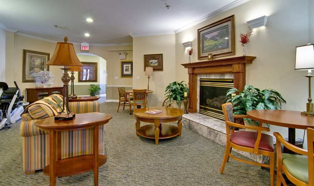 A cozy living room interior with a fireplace and comfortable seating.