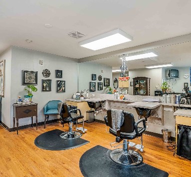 A well-lit hair salon interior with styling chairs and mirrors.