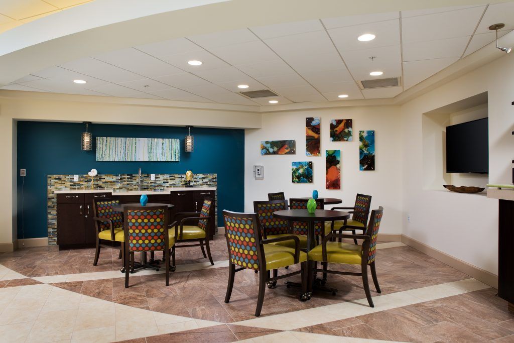A modern dining area with stylish furniture and abstract artwork on the walls.
