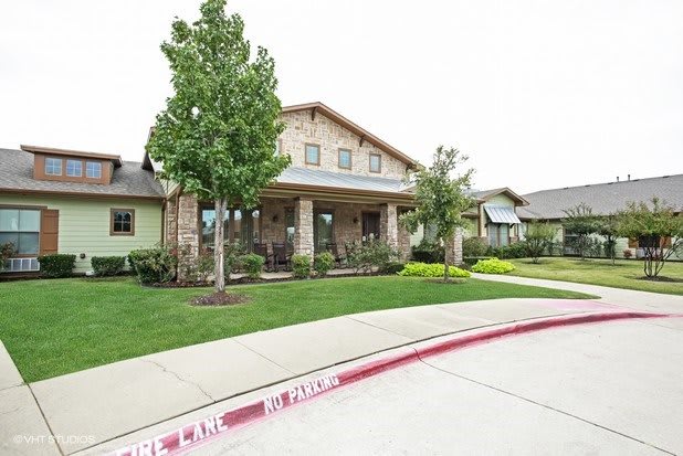 A suburban residential house with a well-maintained front yard and driveway.