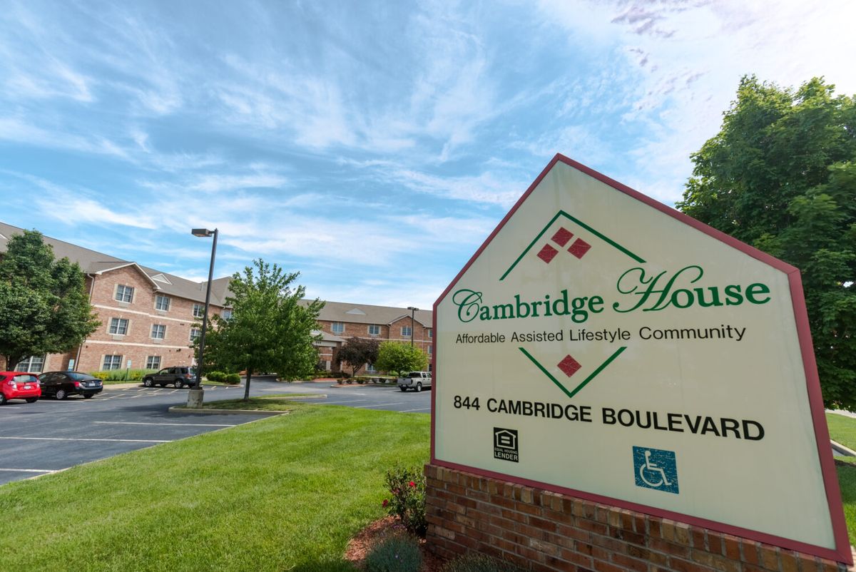 Cambridge House Senior Living community with a prominent entrance sign and surrounding landscape.
