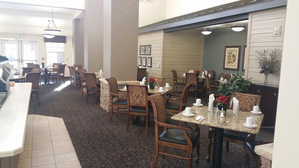An empty dining area with neatly arranged tables and chairs, ready for patrons.