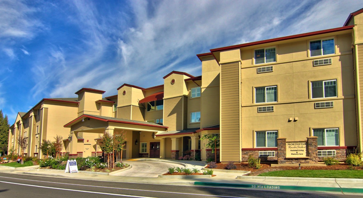 A modern hotel building with a distinctive architectural style under a blue sky.