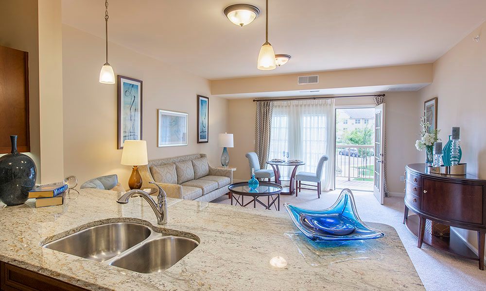Modern open floor plan featuring a stylish living room and kitchen with contemporary decor.