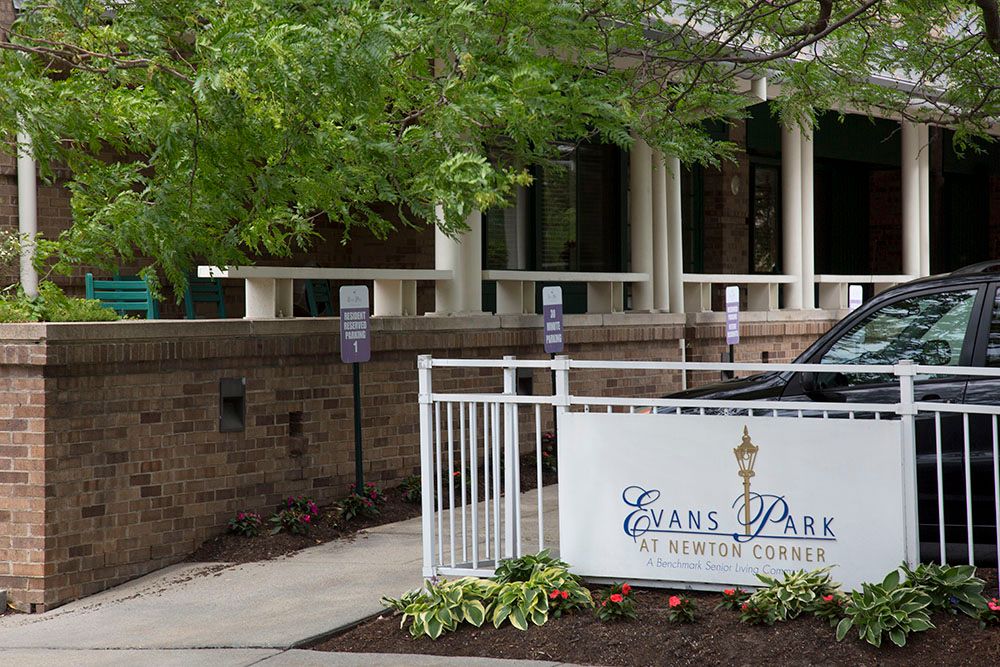 Entrance to a building with a sign reading 'Evans Park at Newton Corner'.