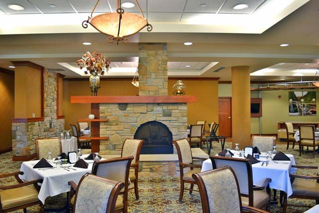 Luxurious restaurant dining area with elegant furnishings and a cozy fireplace.