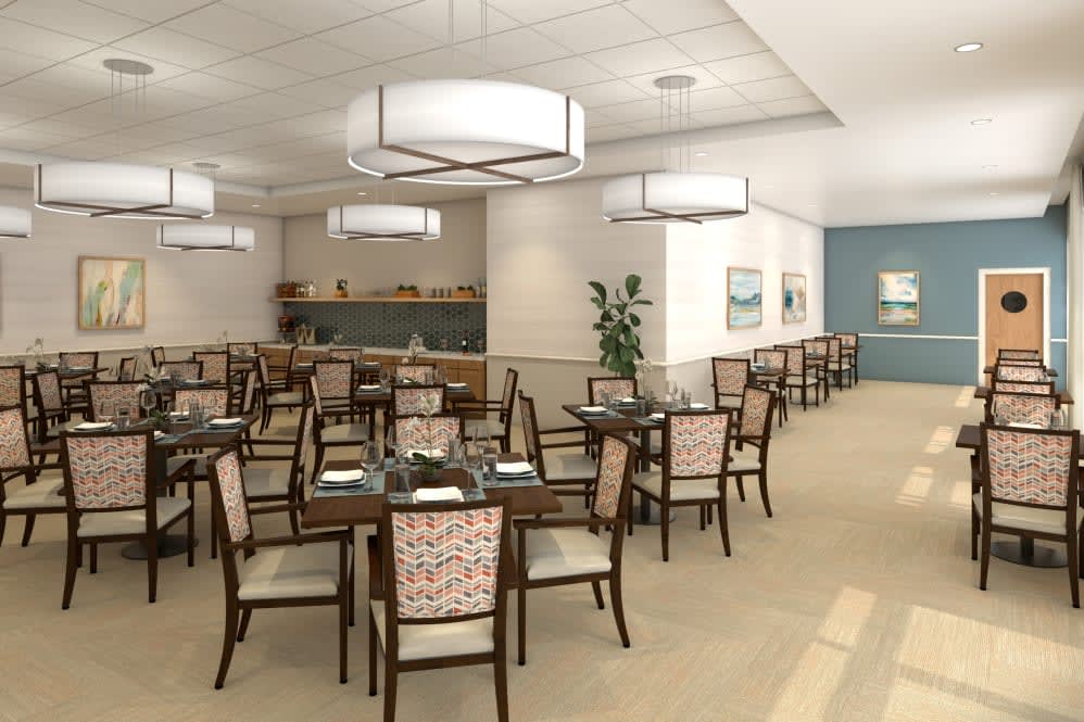 A modern dining area with neatly arranged tables and chairs, featuring contemporary lighting and decor.