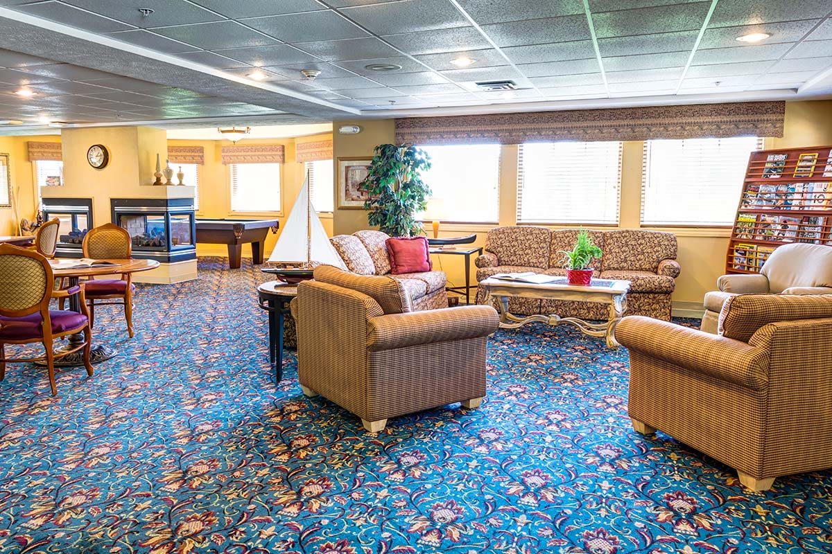 Spacious lounge area with comfortable seating and vibrant carpet design.