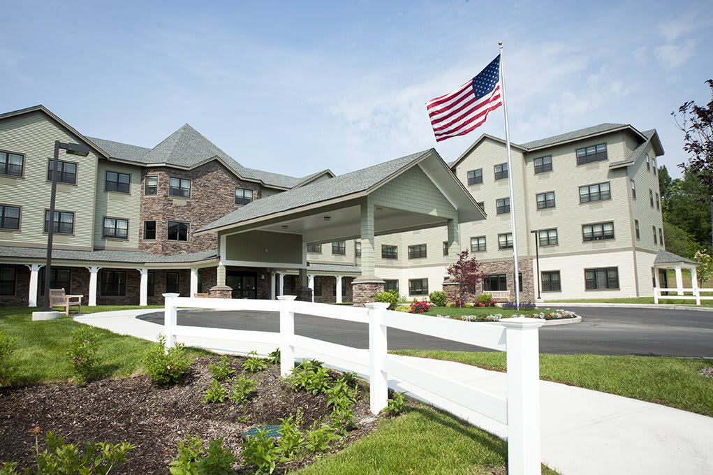 A hotel building with an American flag in the foreground.