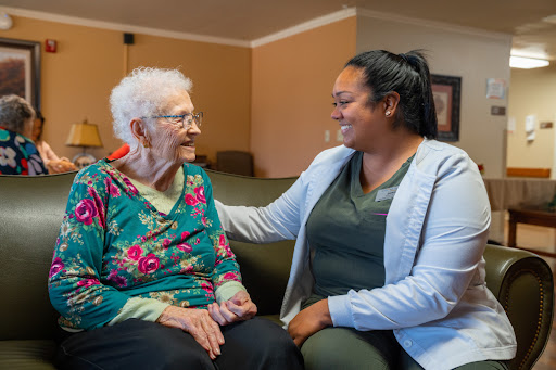 A joyful moment of connection between a caregiver and an elderly resident.
