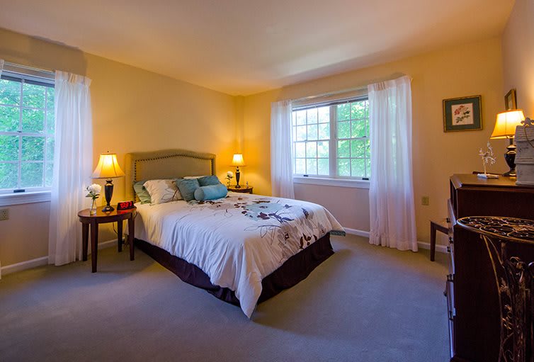 A cozy, well-lit bedroom with a comfortable bed and elegant decor.