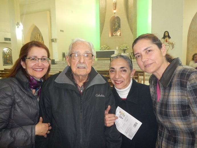 A group of people posing happily together inside a church.