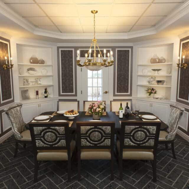 A beautifully designed dining room featuring an elegant chandelier, a well-set table, and stylish decor.
