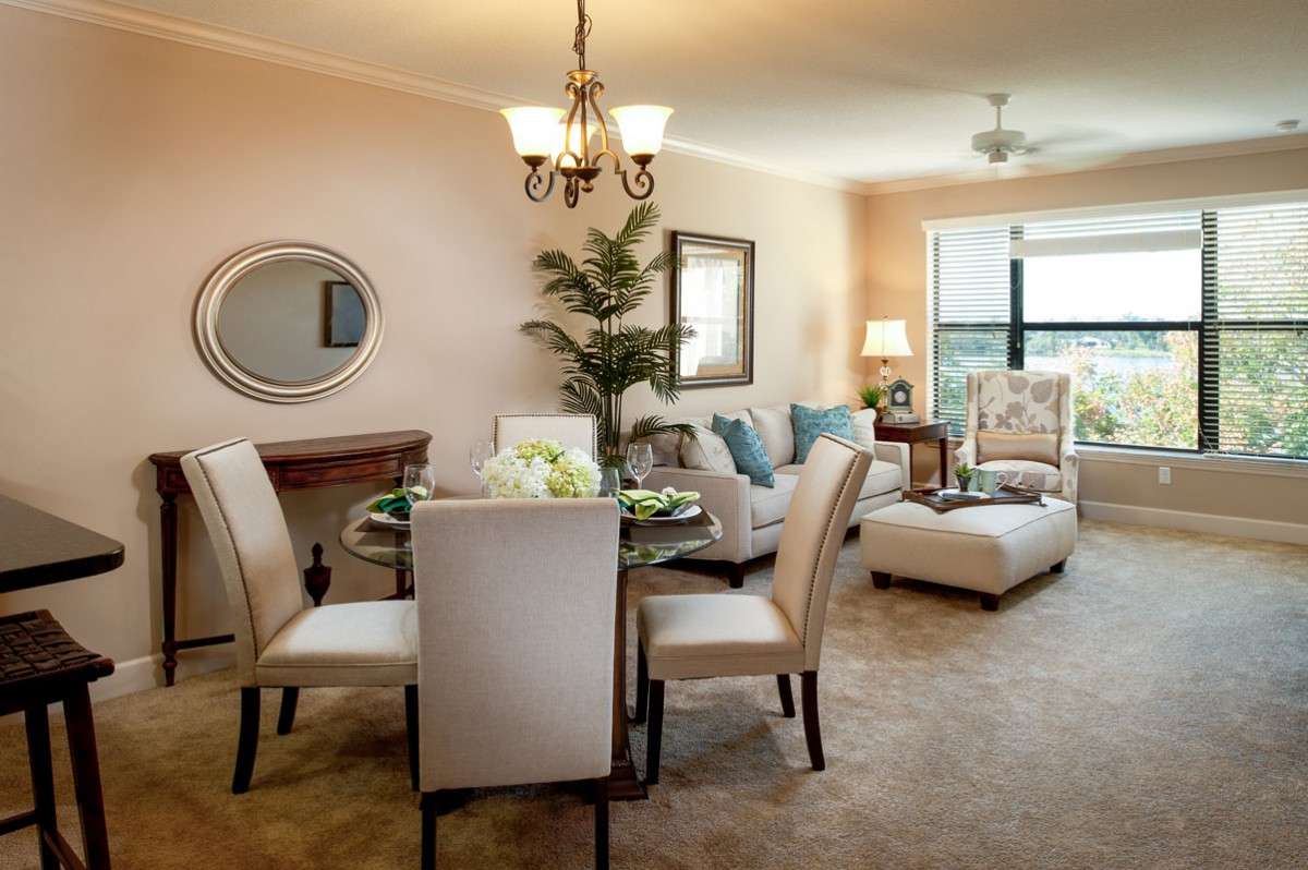 A cozy living and dining space with modern furniture and neutral tones, enhanced by natural light.