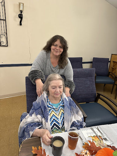 A warm moment shared between two women in a community setting.