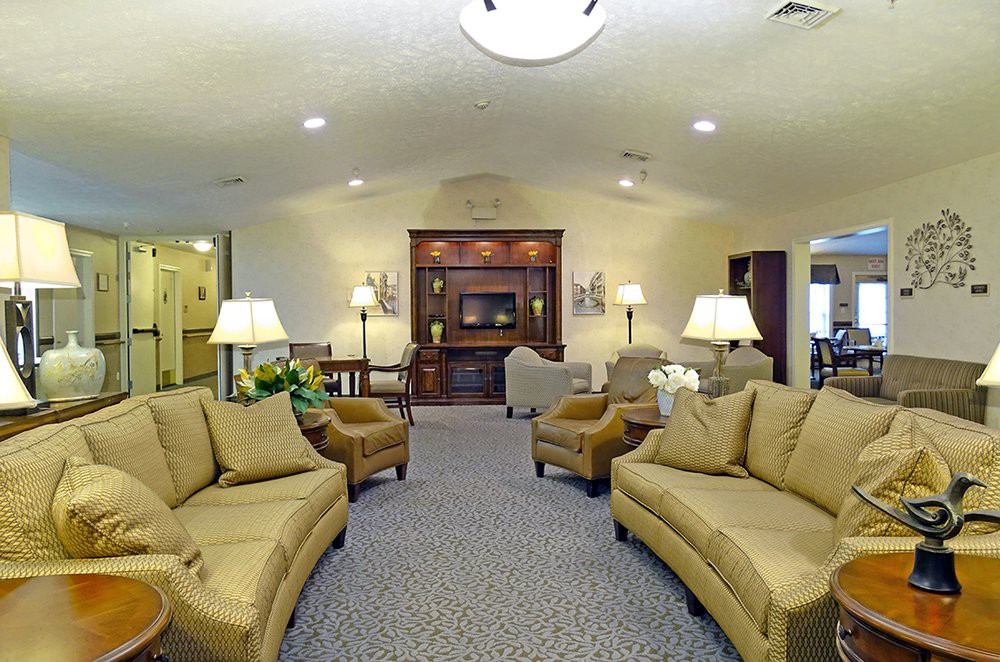 A spacious living room with comfortable seating and warm lighting.