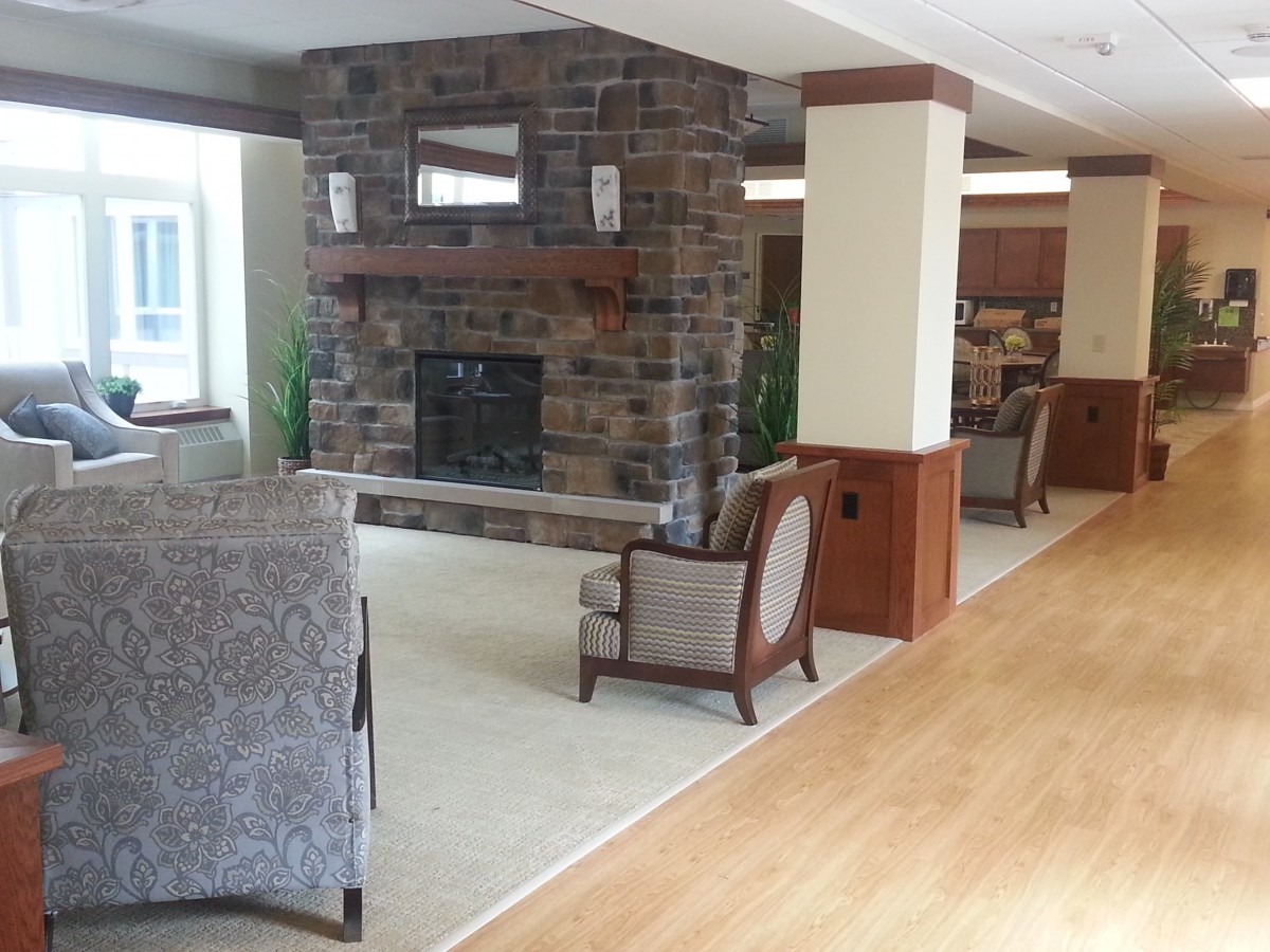 A cozy living area with a stone fireplace and comfortable seating.