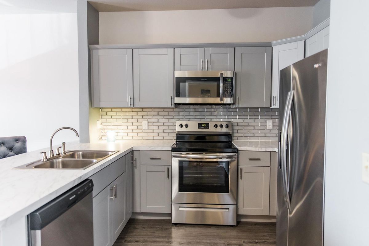A modern kitchen with stainless steel appliances and sleek cabinetry.