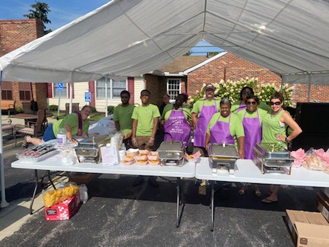 Volunteers serving delicious food at a community gathering.