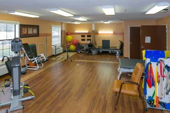 A well-equipped physical therapy room with exercise machines and tools.