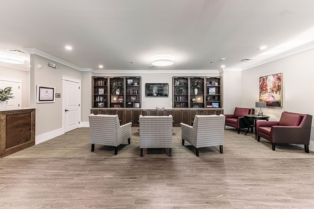 A modern living room with comfortable seating and stylish bookshelves.