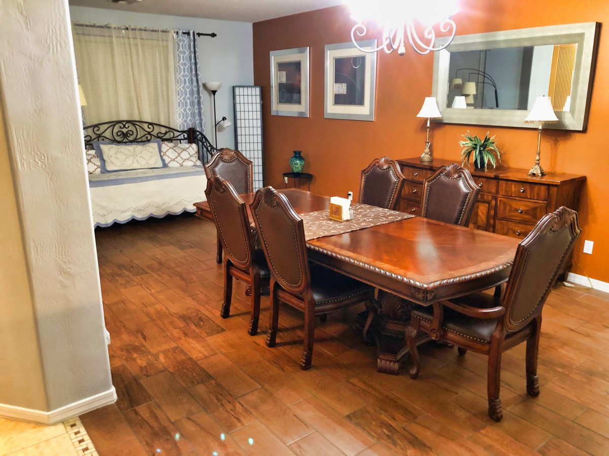 A cozy dining room with a wooden table and chairs, complemented by warm-toned walls and elegant decor.