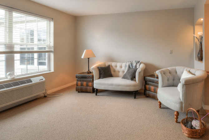 A cozy living room with neutral-colored sofas and a lamp by the window.