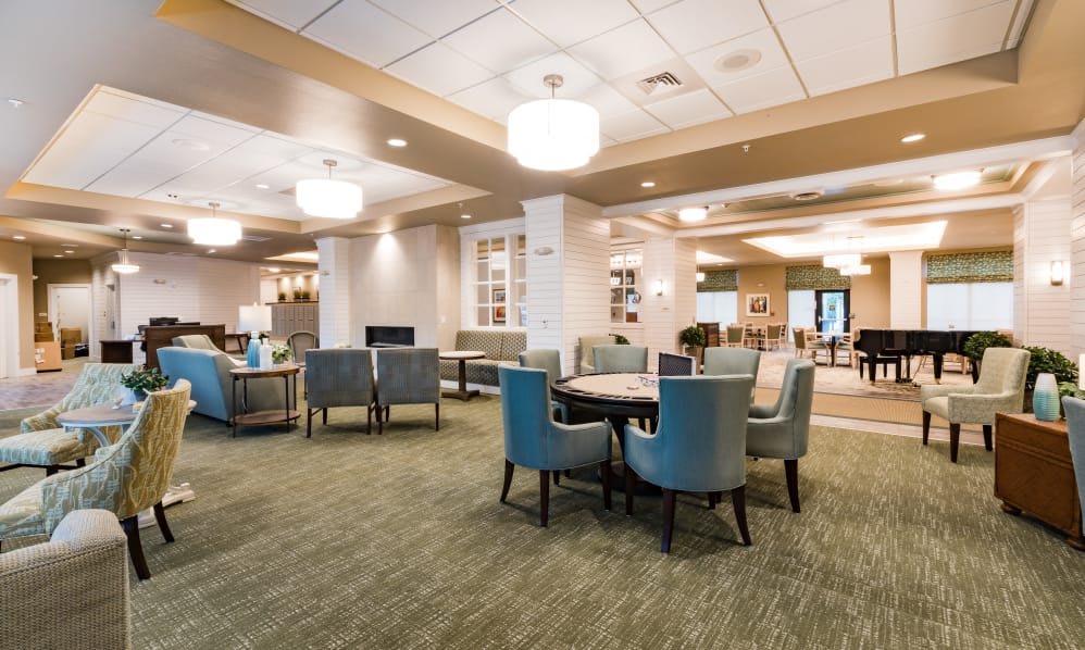 A spacious and elegantly designed interior lounge area featuring comfortable seating and modern lighting.