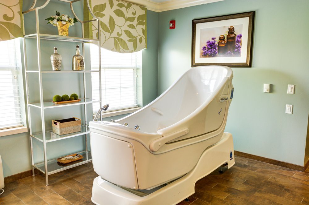 A modern spa room featuring a luxurious bathtub designed for relaxation and wellness.