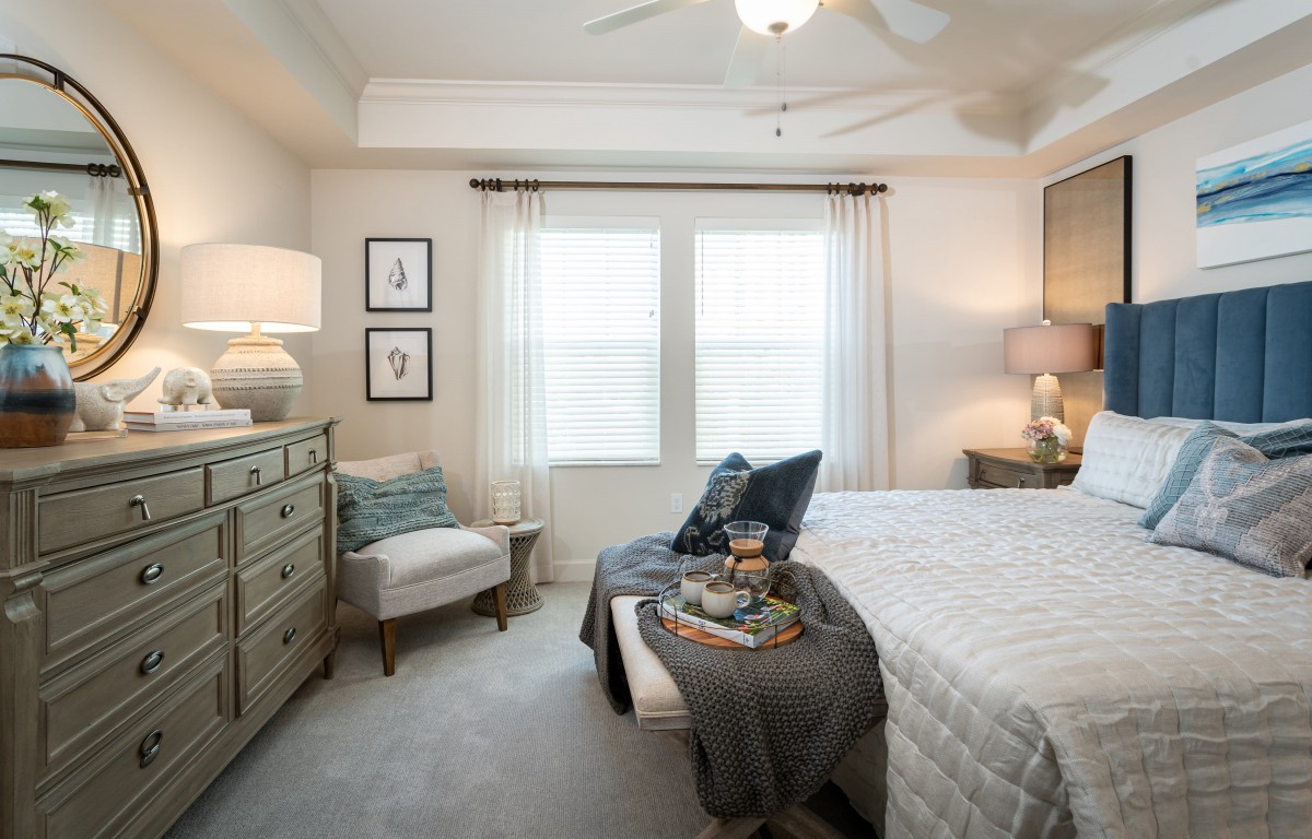 A cozy and modern bedroom with tasteful decor and ample natural lighting.