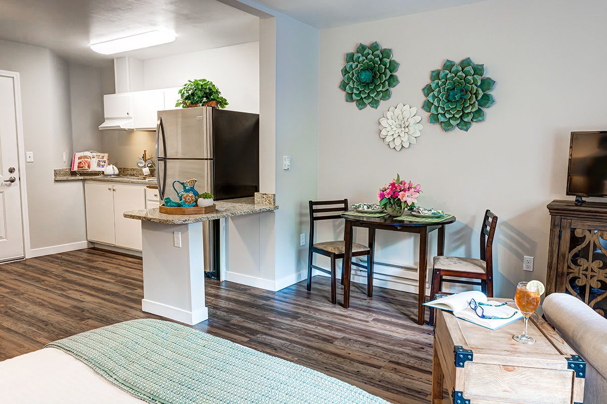 A cozy apartment kitchen and dining area with modern decor and wood flooring.