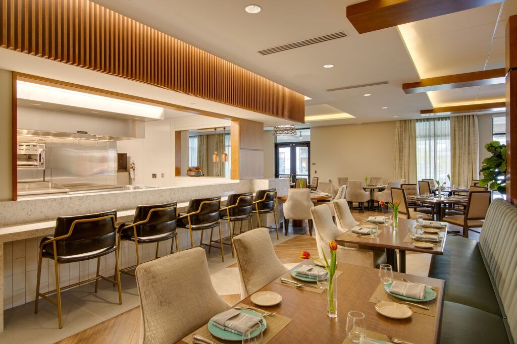 A modern restaurant interior featuring a well-arranged dining area with comfortable seating.