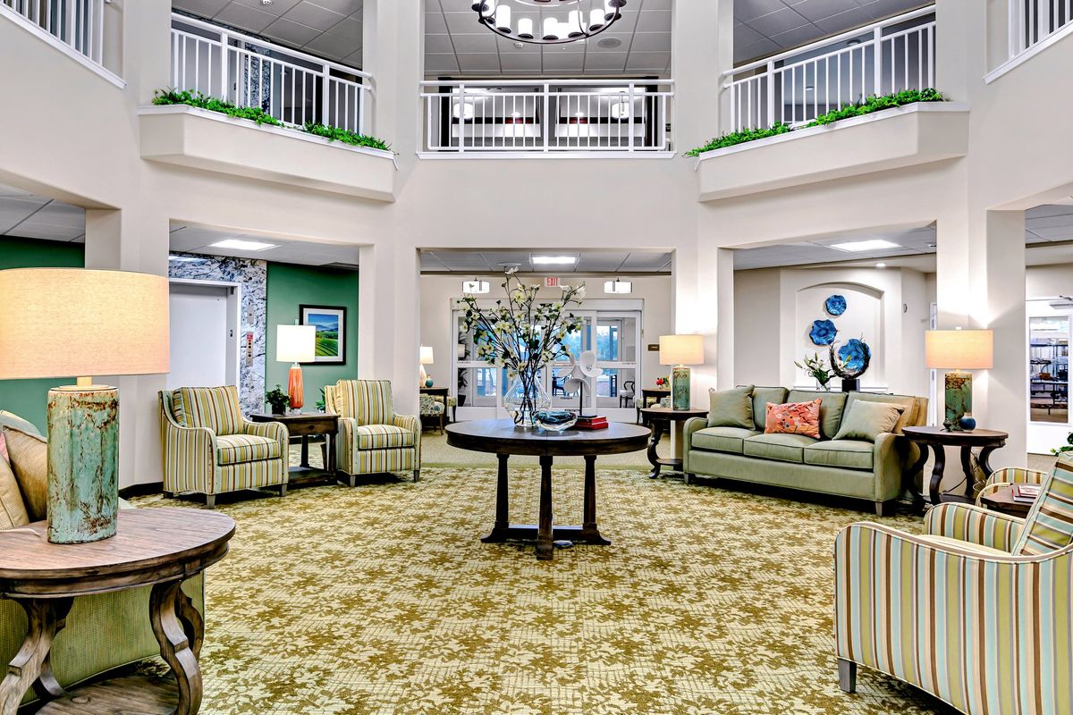 A spacious and elegantly decorated lobby with comfortable seating and a chandelier.