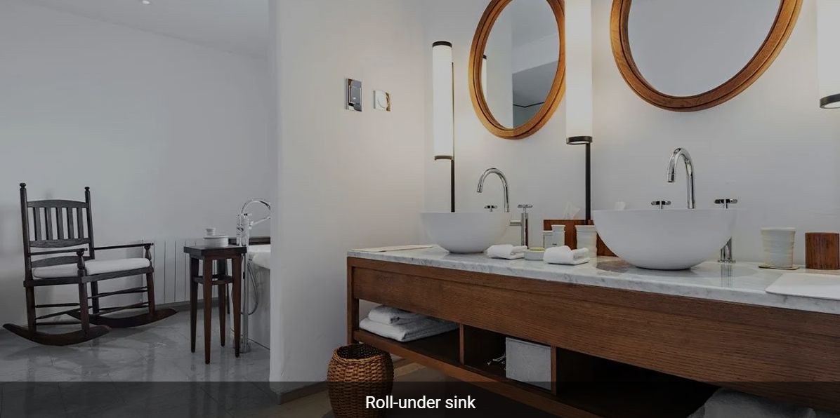 A modern bathroom with a wooden vanity, dual sinks, and round mirrors.