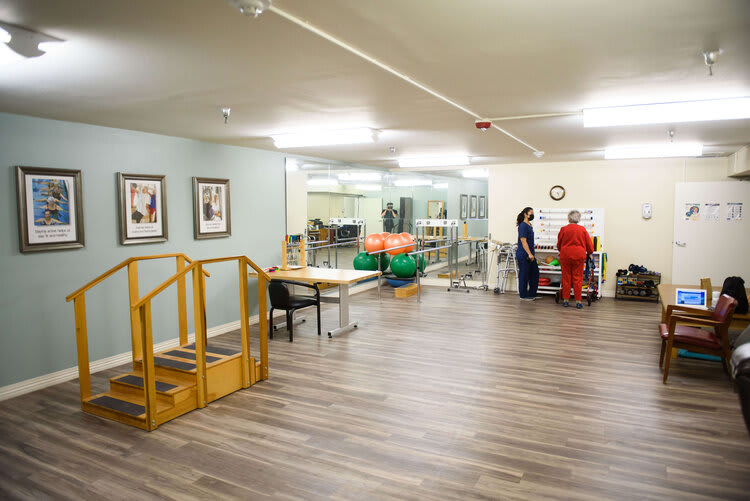 A rehabilitation room equipped with exercise tools and a staircase for physical therapy.