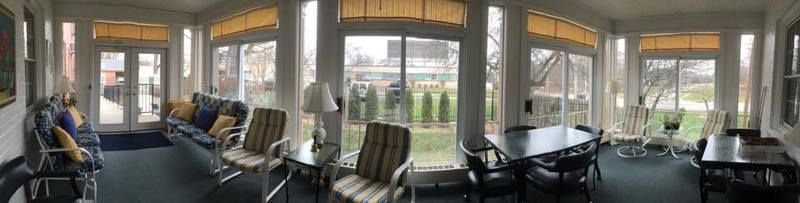 A cozy room with a large window overlooking a garden.