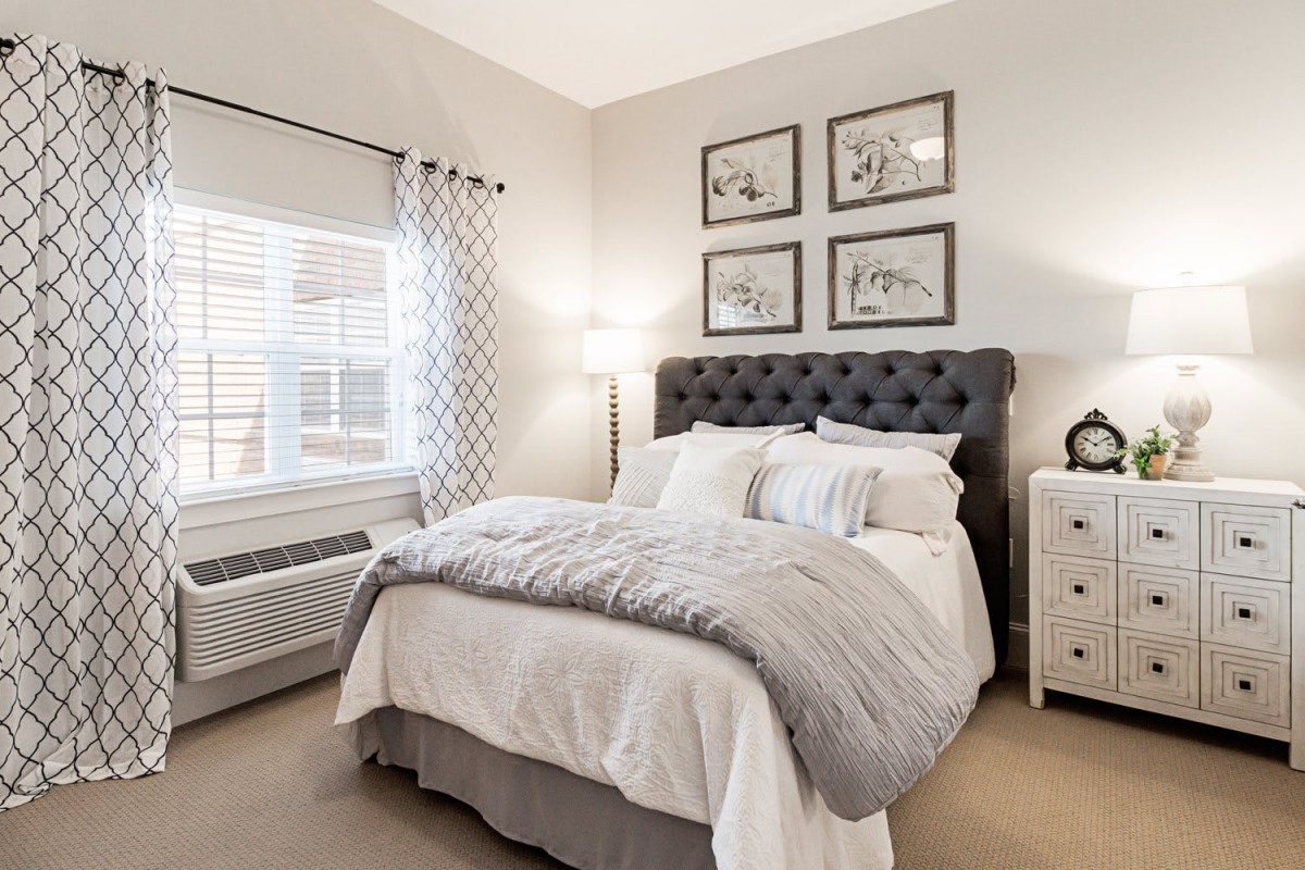 A cozy and elegantly decorated bedroom with neutral tones and modern furnishings.