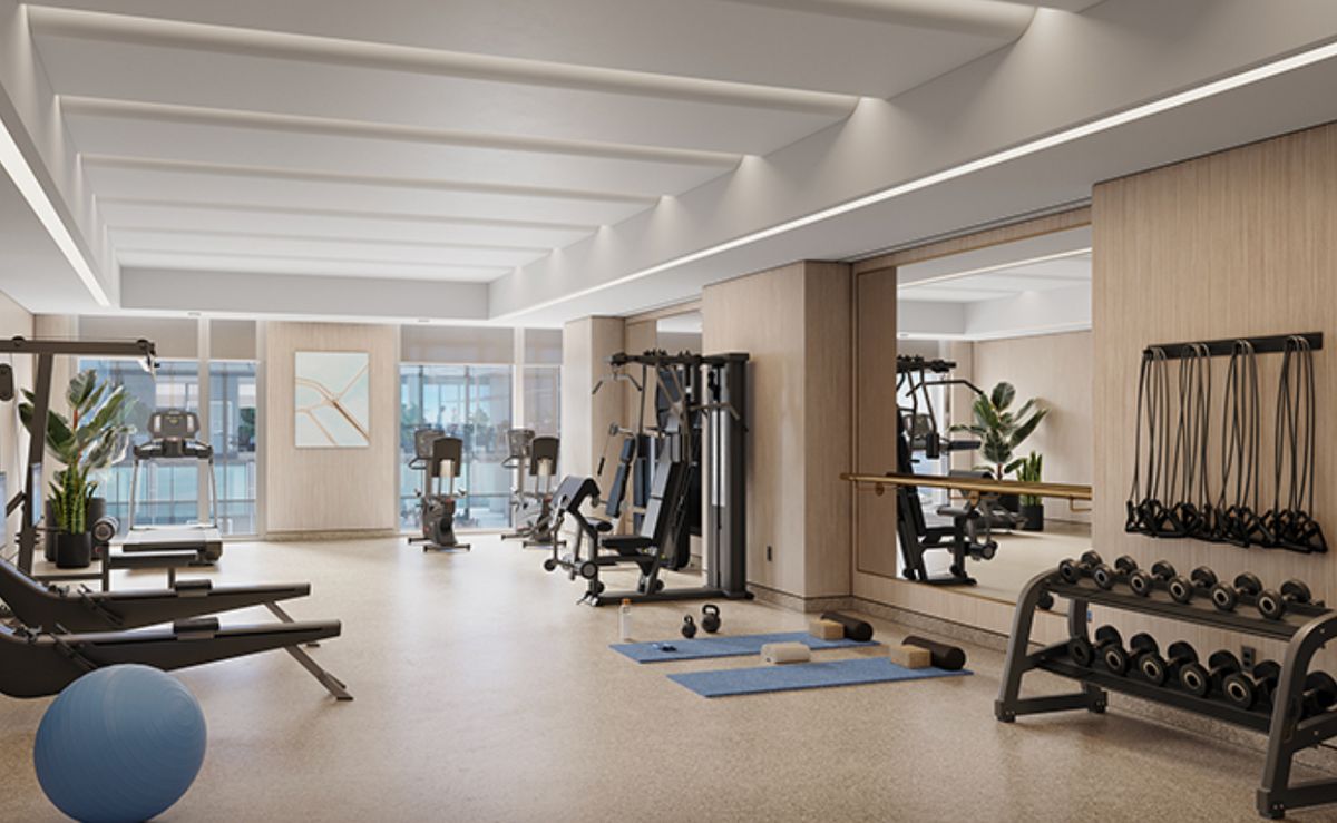 A modern gym with various exercise equipment and a spacious workout area.