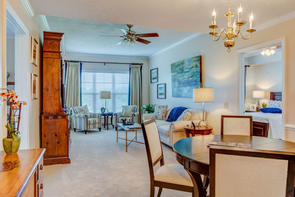 A well-decorated living room featuring classic furniture and a chandelier.