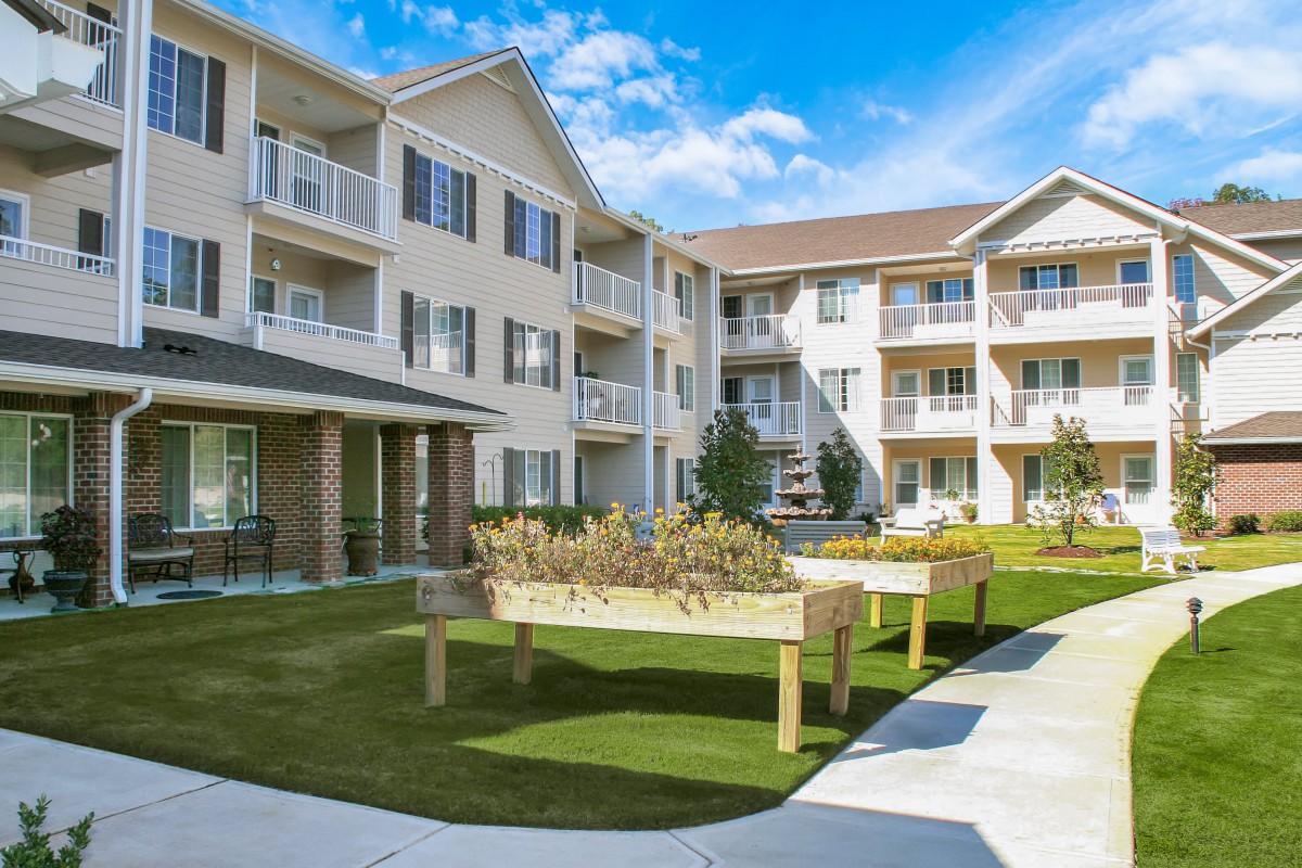 A modern residential apartment building with landscaped outdoor space.