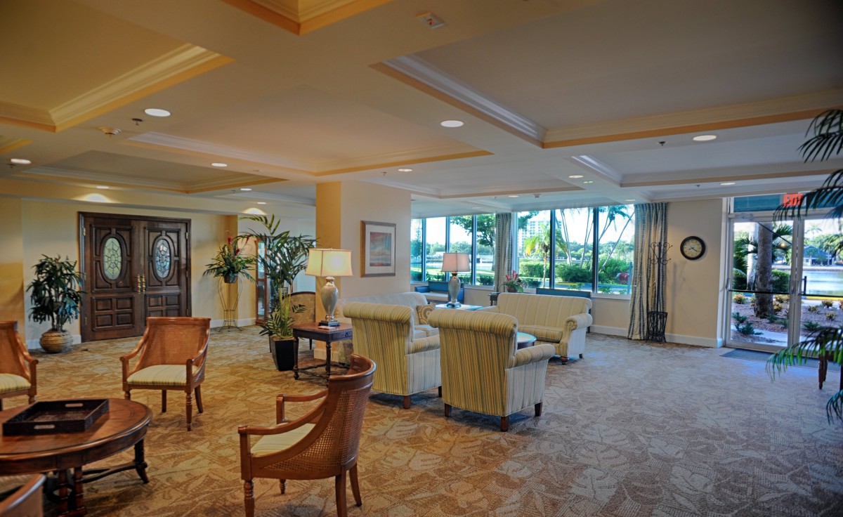 A spacious and elegantly furnished lobby area with comfortable seating and large windows.